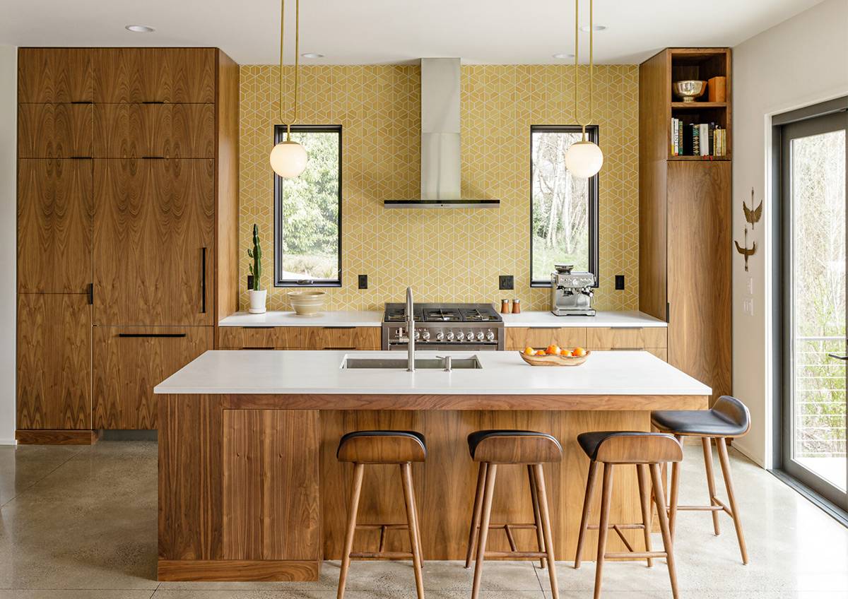 large mid century modern kitchen with teak wood cabinetry with yellow backsplash