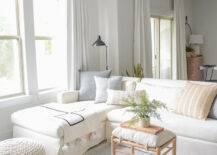 studio-mcgee-co-styled-pillows-white-slip-cover-sofa-upholstered-wooden-ottoman-straps-malta-woven-rug-how-to-arrange-pillows-sofa-with-chaise-1-79766-217x155