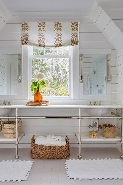 Bathroom features a nickel and marble double washstand with white pom pom bath mats and frameless medicine cabinets on white shiplap walls.