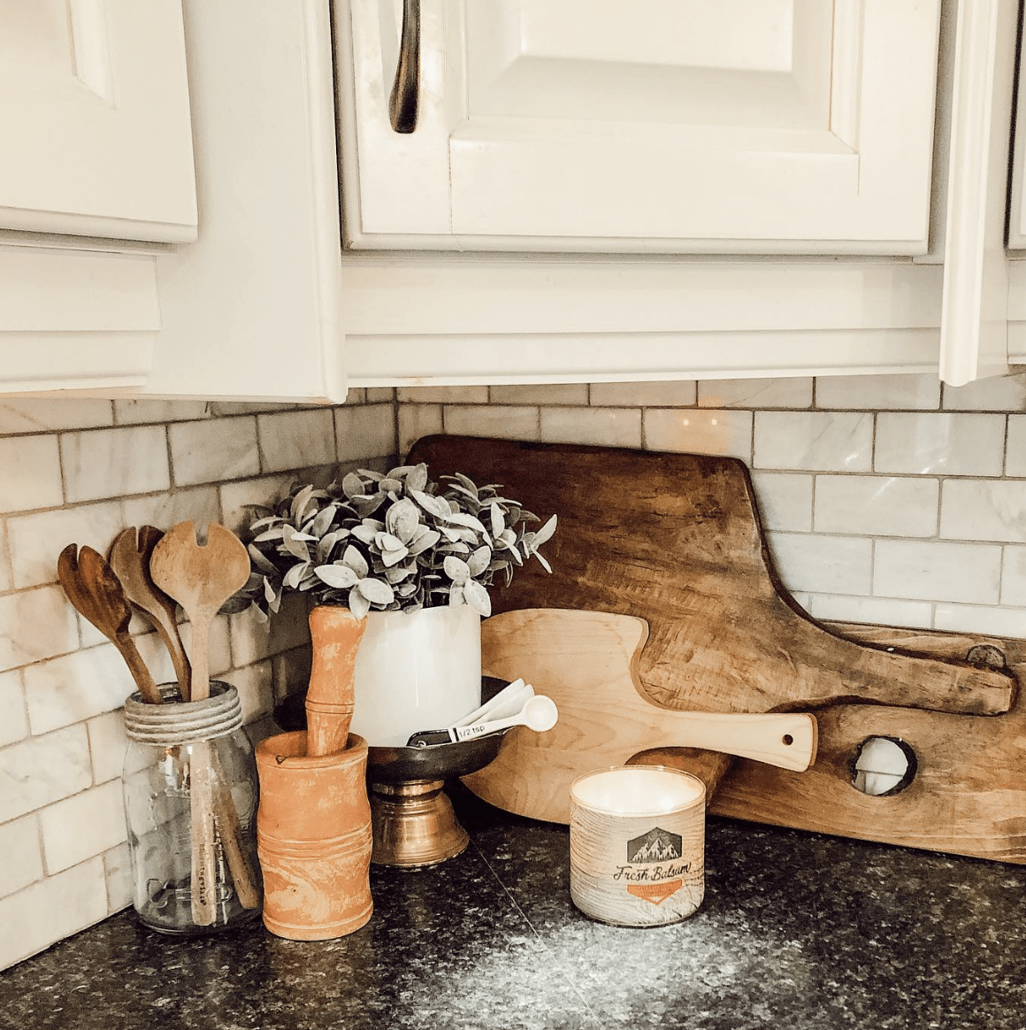 Kitchen counter corner with cooking utensils. 