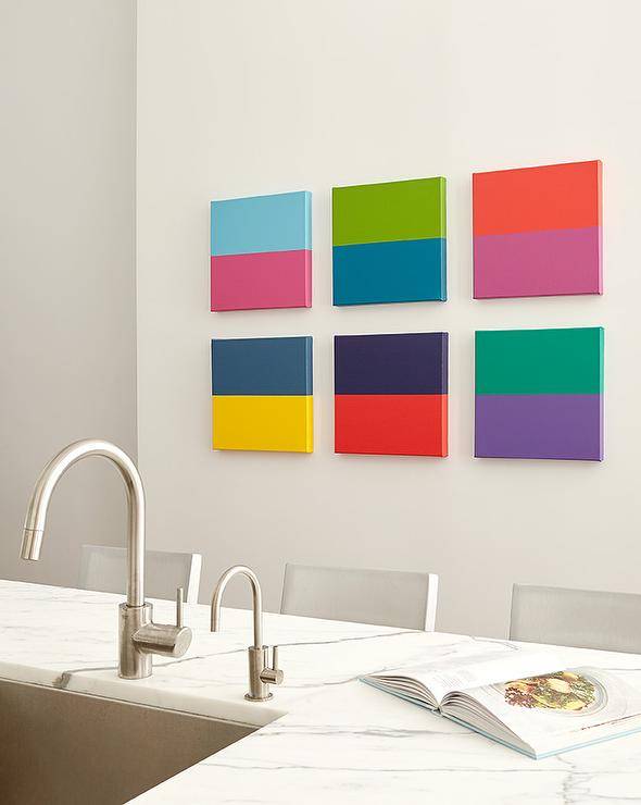 Kitchen wall features a color block art gallery and island sink with nickel gooseneck faucet.