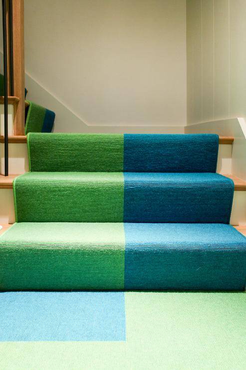 A green and blue color block runner is featured on a staircase.