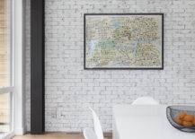 white brick accent wall with colorful map and black steel beam