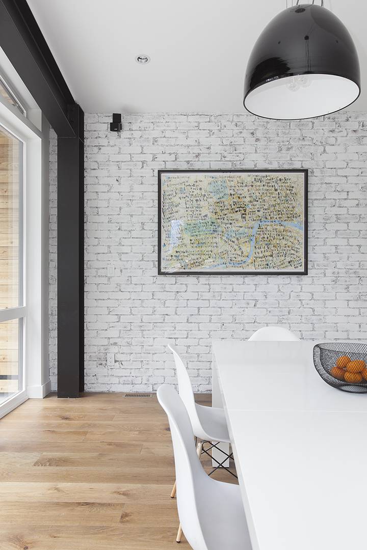 white brick accent wall with colorful map and black steel beam