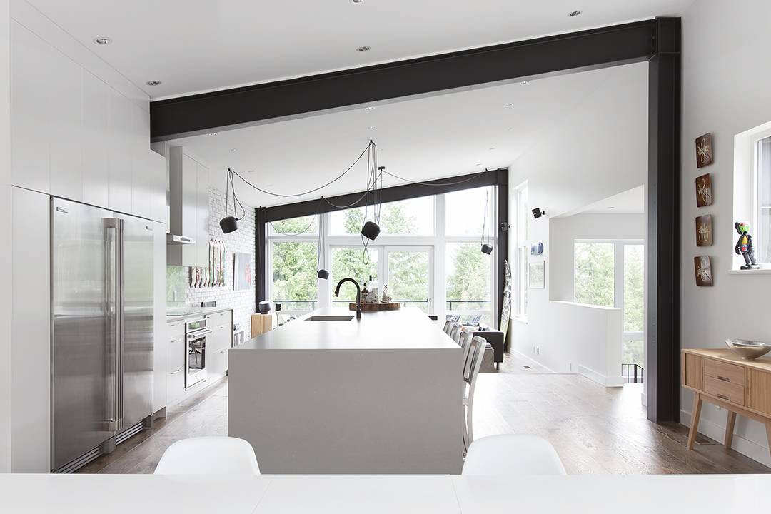 wide shot of industrial white open concept main floor with black and wood accents