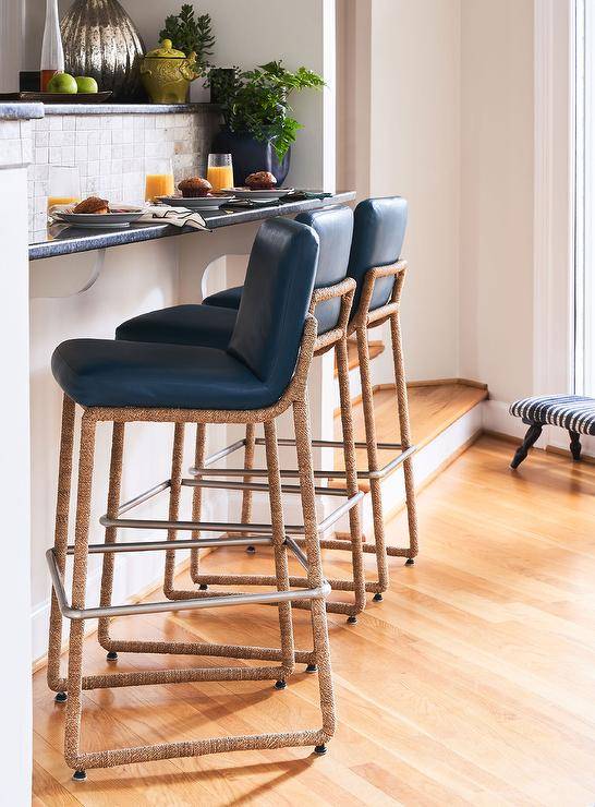 Kitchen features navy blue leather and rope stools at a blue and gray tiled bar.