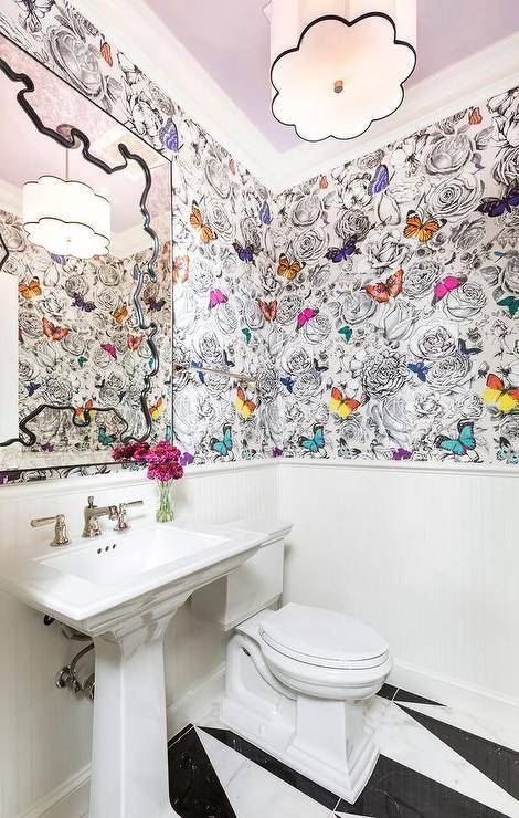 Colorful contemporary kid's bathroom with lavender ceiling in front of an antique mirror, black and white buttlerfly wallpaper with pops of color, with a white pedestal sink