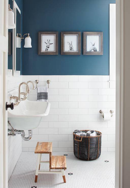 colorblock navy blue and white tiled bathroom with minimalist vanity sink and step stool