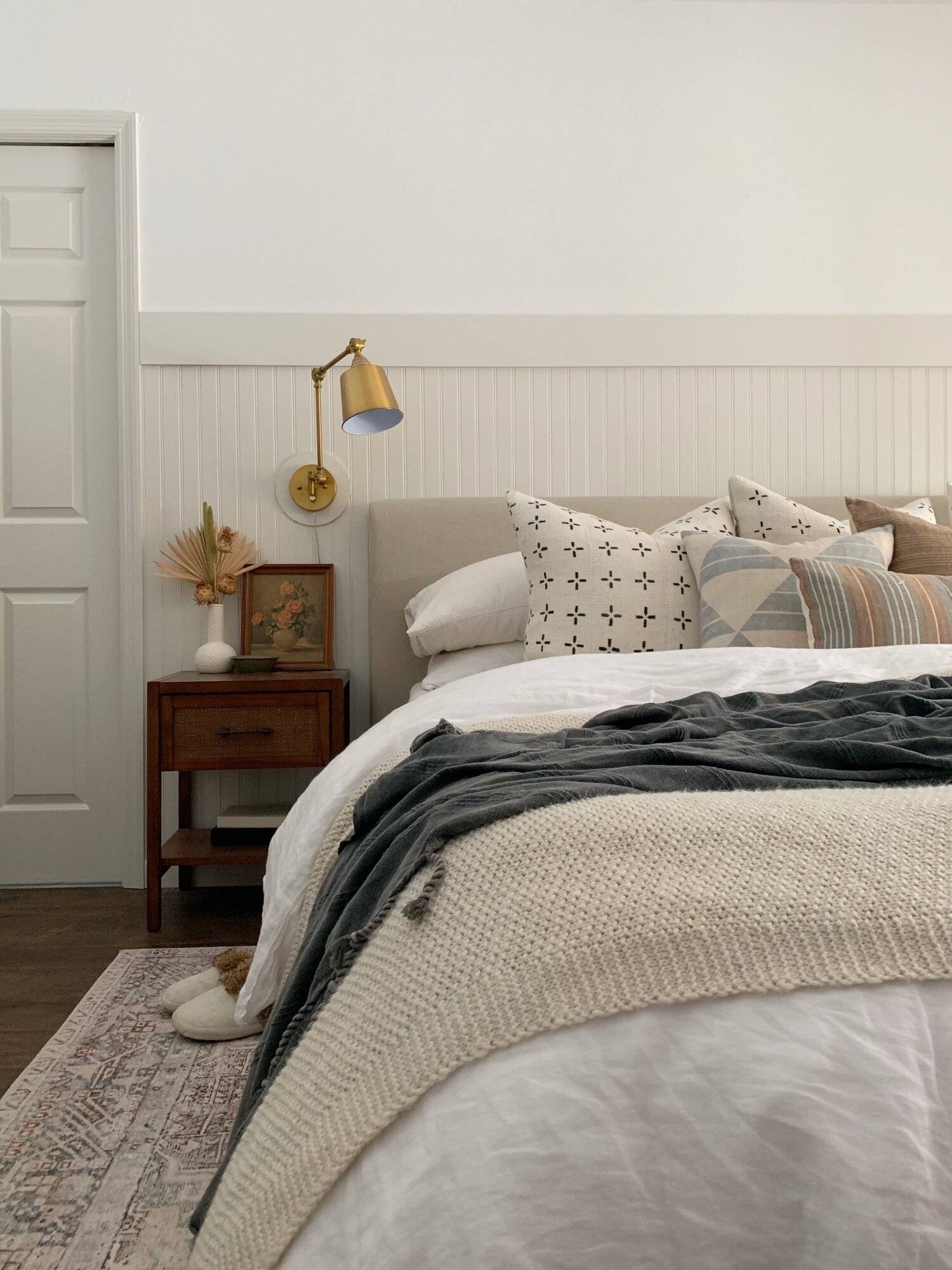 a bed styled with layers of pillows and blankets