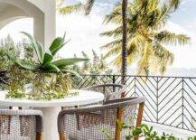 Covered patio features gray wicker and rope dining chairs at a white pedestal table.