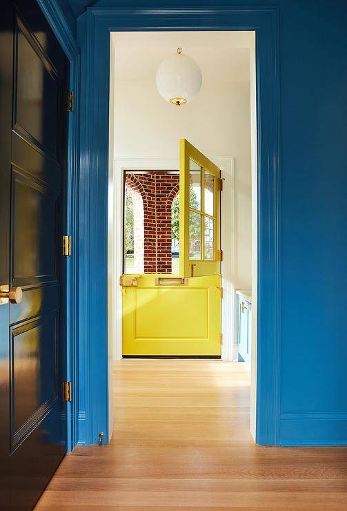 Glossy blue door trim accents a bright blue wall.