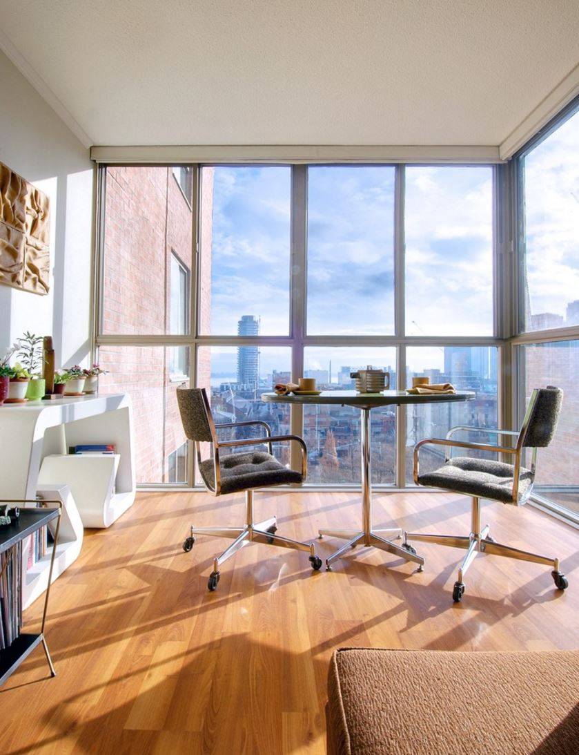 Breakfast corner in a condo with floor-to-ceiling windows.