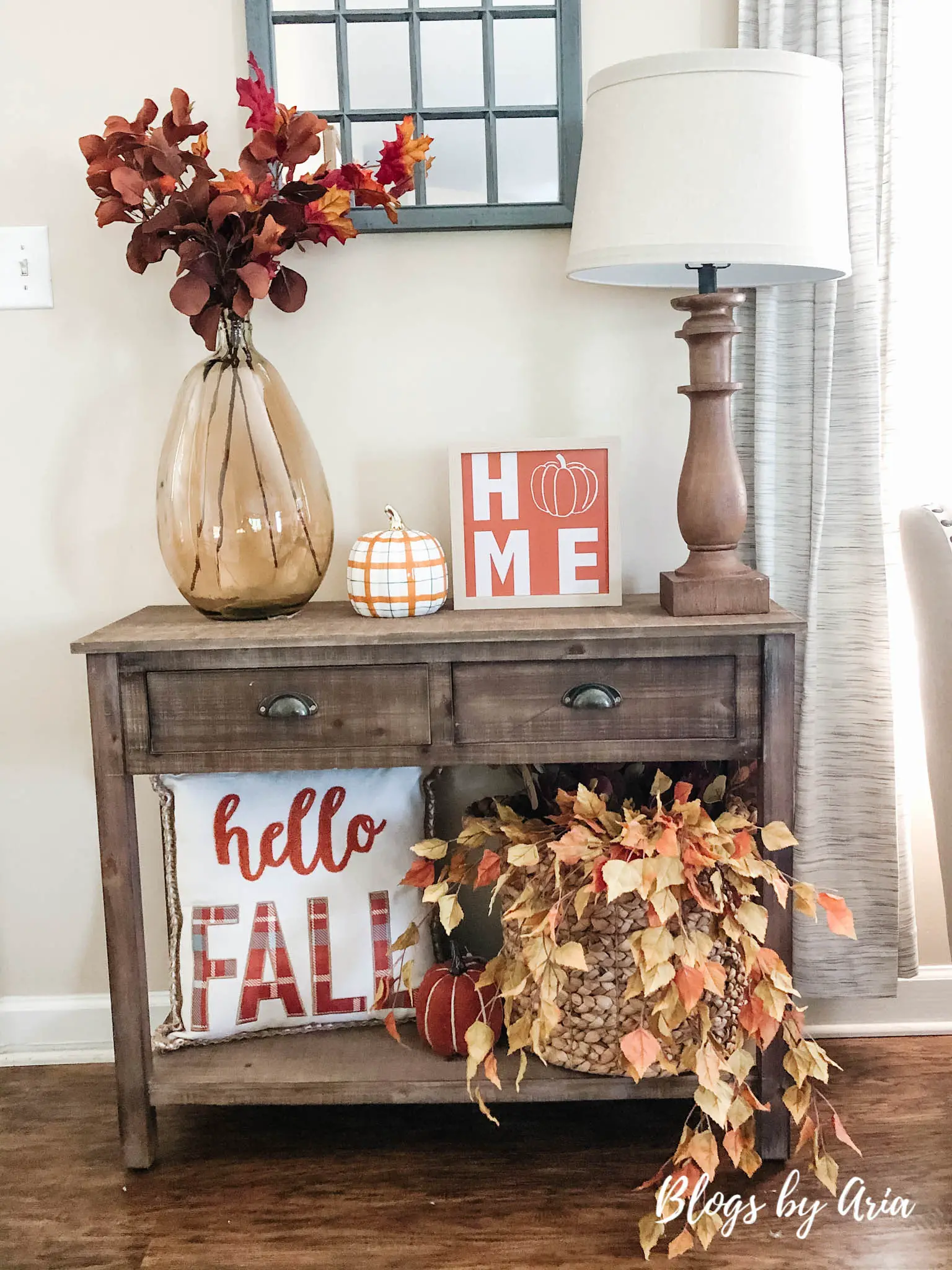 Fall entryway with a pillow with writing that reads hello FALL.