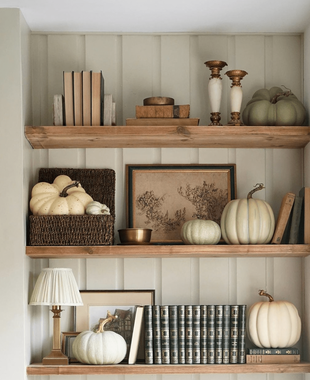 Fall home decor bookshelves with pumpkins.
