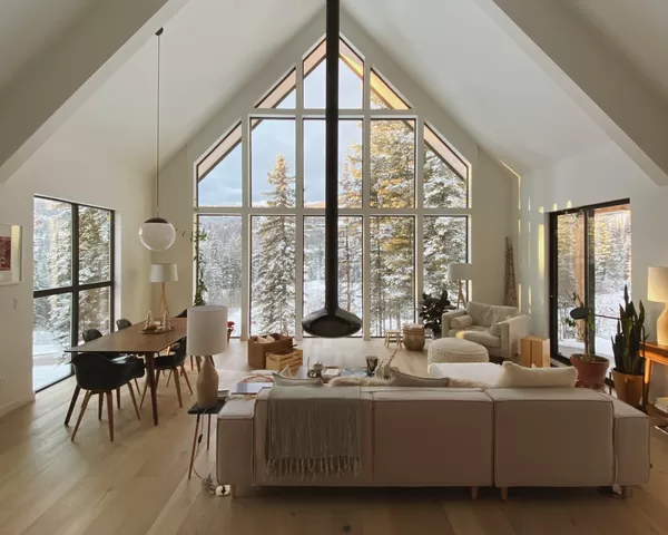 Black fireplace installed in front of a modern floor-to-ceiling window.