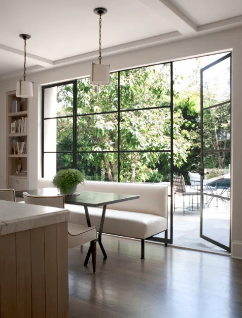 Modern kitchen with floor-to-ceiling windows that double as door to the backyard.