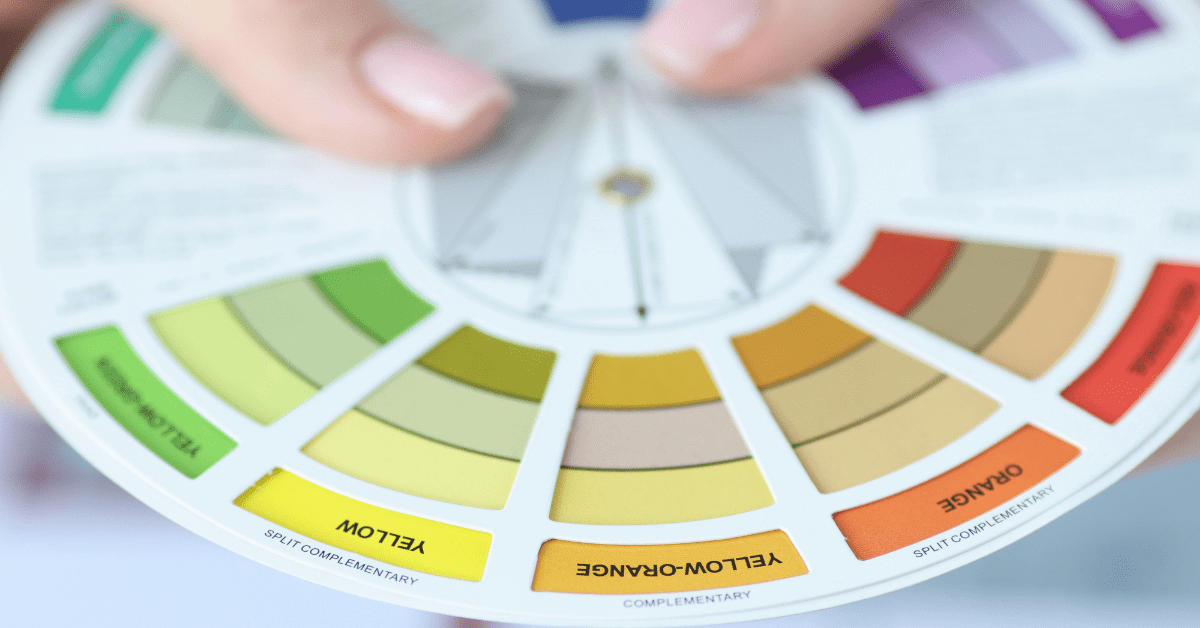 Person holding color palette in hand.