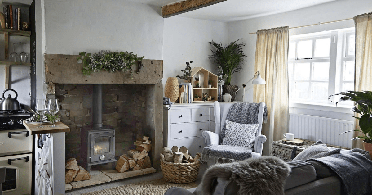 Cottagecore living room with wood-burning stove and wicker basket.