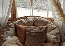 brown beige papasan chair with hanging star christmas faux fur rug boho pillows