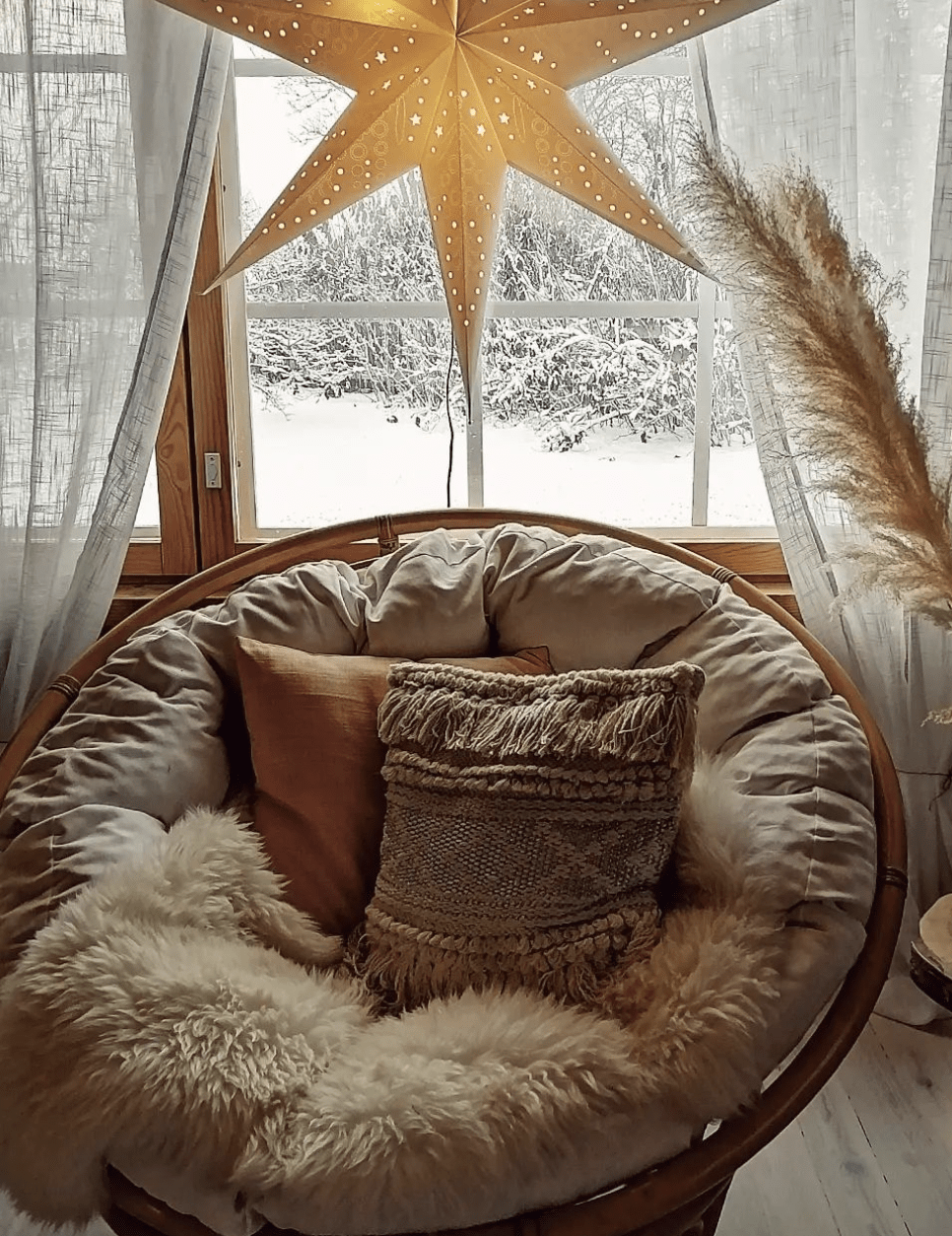 brown beige papasan chair with hanging star christmas faux fur rug boho pillows