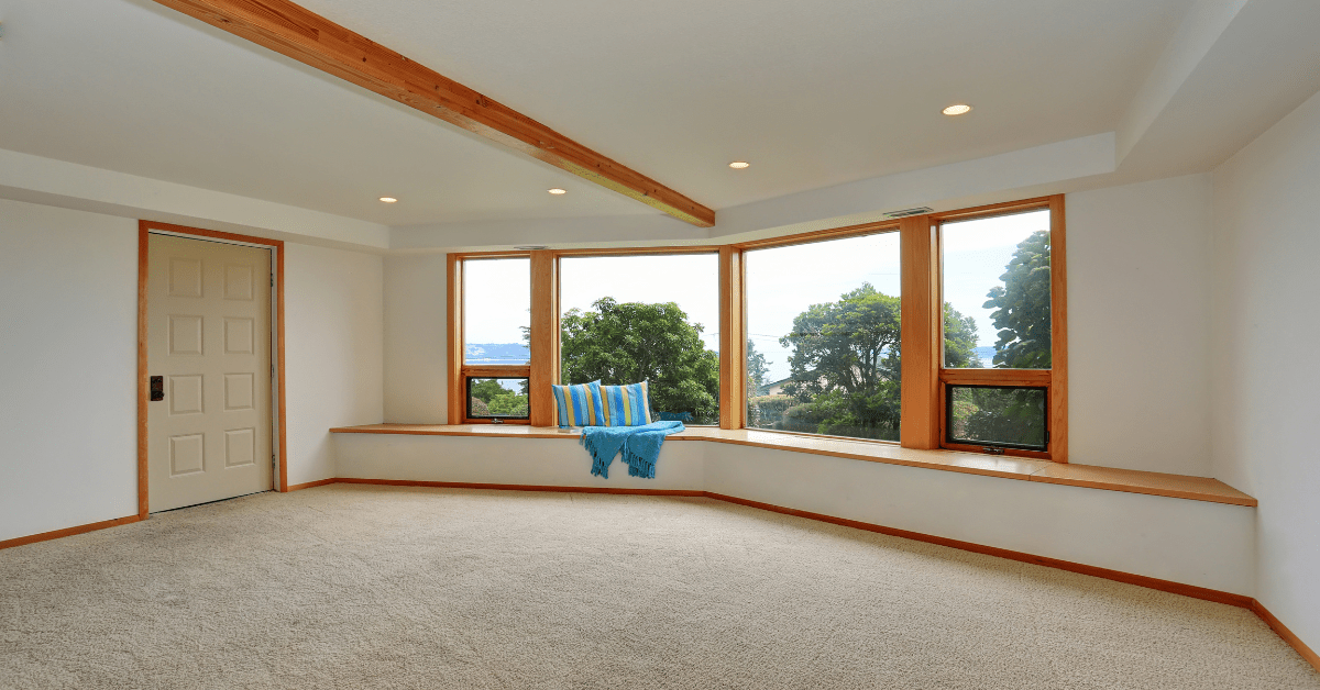 Empty living room with wall-to-wall carpet.