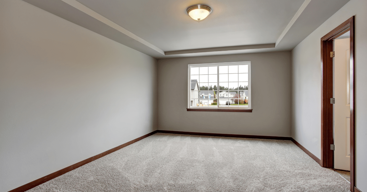 Empty room with wall-to-wall carpet.