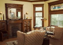 Living room of a Victorian style house with stained glass and wooden accents.