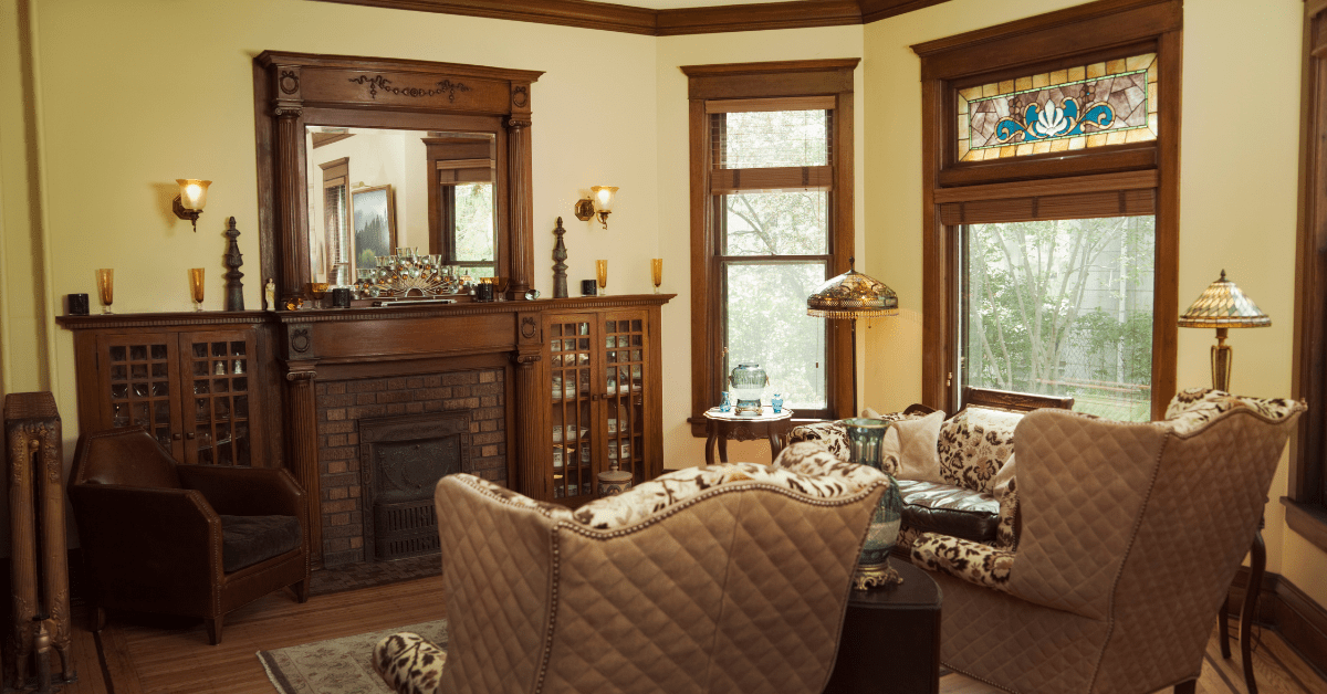 Living room of a Victorian style house with stained glass and wooden accents.