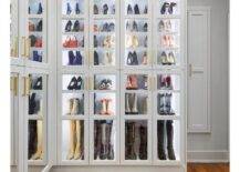 Glam closet features stacked, glass-front shoe cabinets with custom lighting.