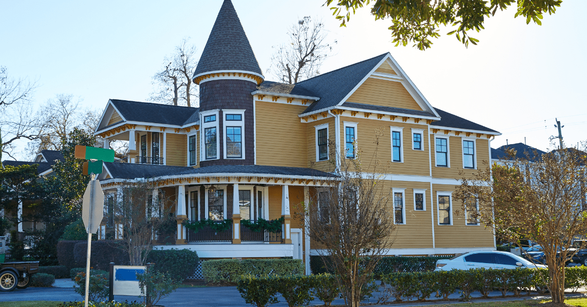 A Victorian style house with yellow painted exterior walls.