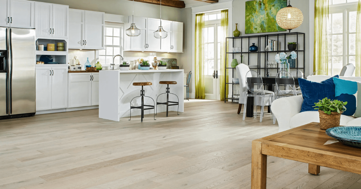 Light themed kitchen with bleached wood flooring.