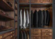 Men's closet design features veneer cabinet doors adorned with leather and brass hardware, built in shoe shelves and brass clothes rails.