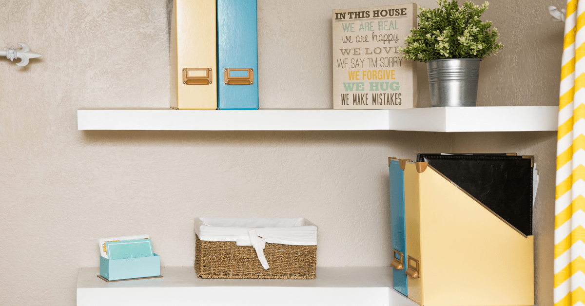 DIY floating shelves in a corner of a small space.