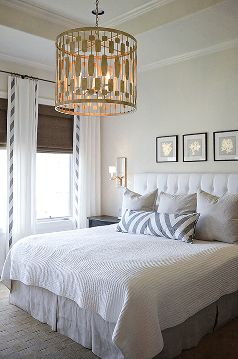 Clean, neutral bedroom with a custom Schumacher bolster and beautiful Circa light fixture. Custom drapery and a custom headboard complete the look. A dream for rainy days and breakfast in bed.