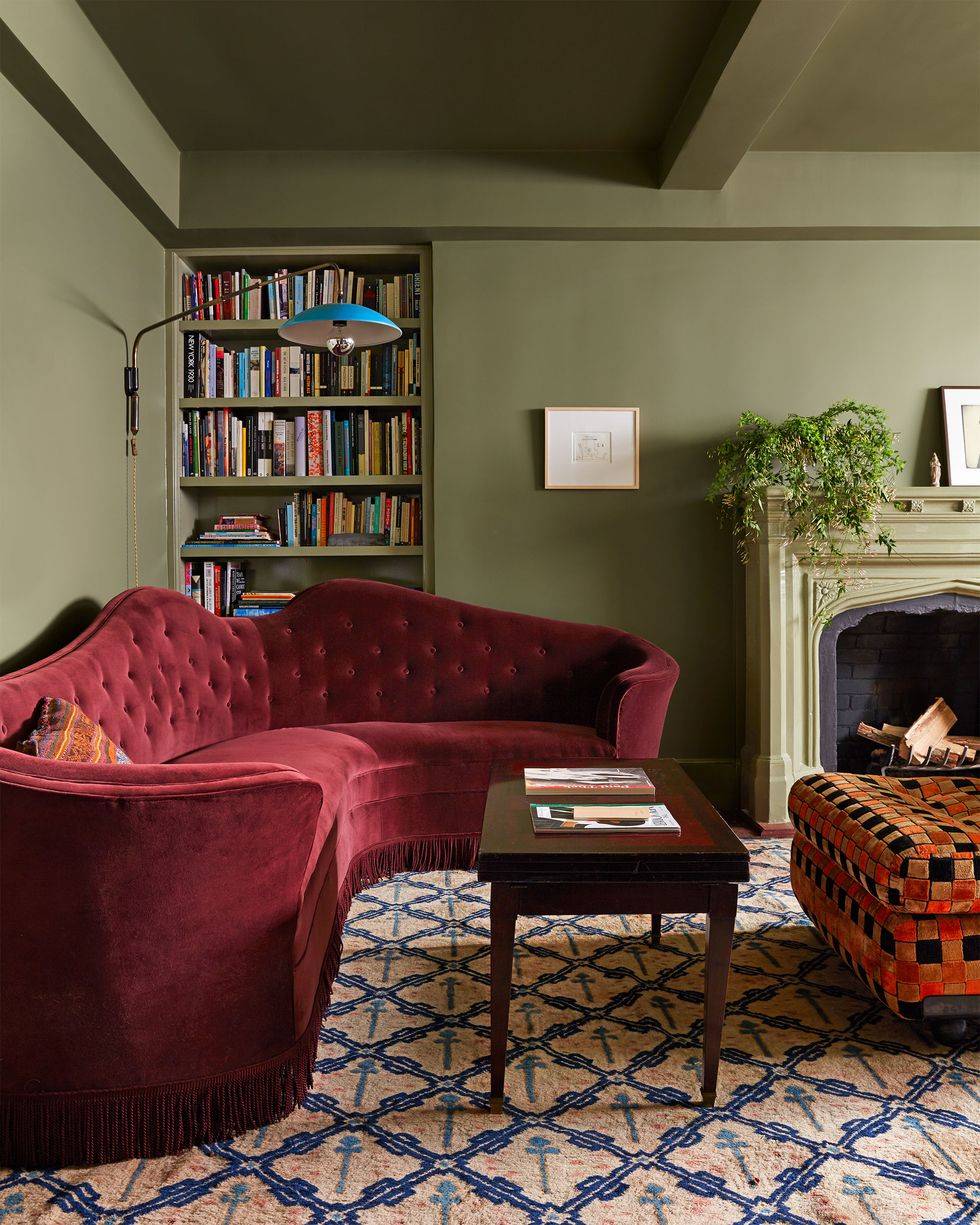 sage green and burgundy home design interior room living room with book shelf