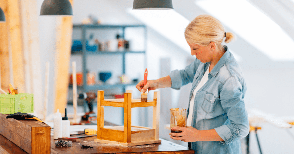 Woman painting a piece of furniture.