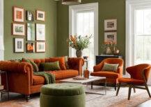 Living room with olive green walls and burnt orange furniture.