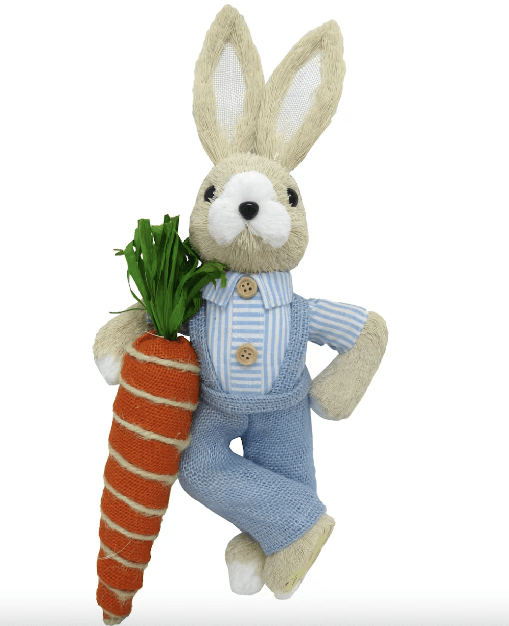 sisal bunny wearing blue overalls leaning on carrot