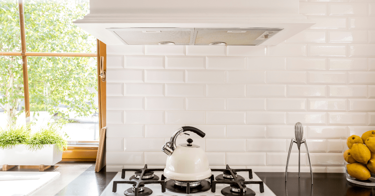 White kitchen with white tile backsplash.