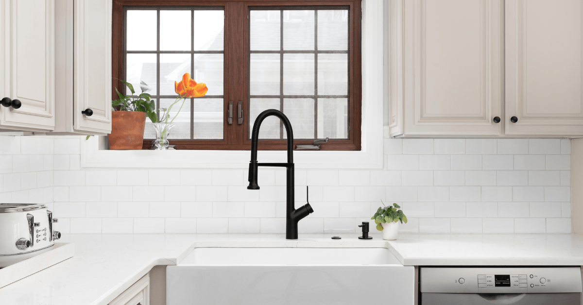 White kitchen with white tile backsplash.