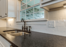A kitchen with black countertops.