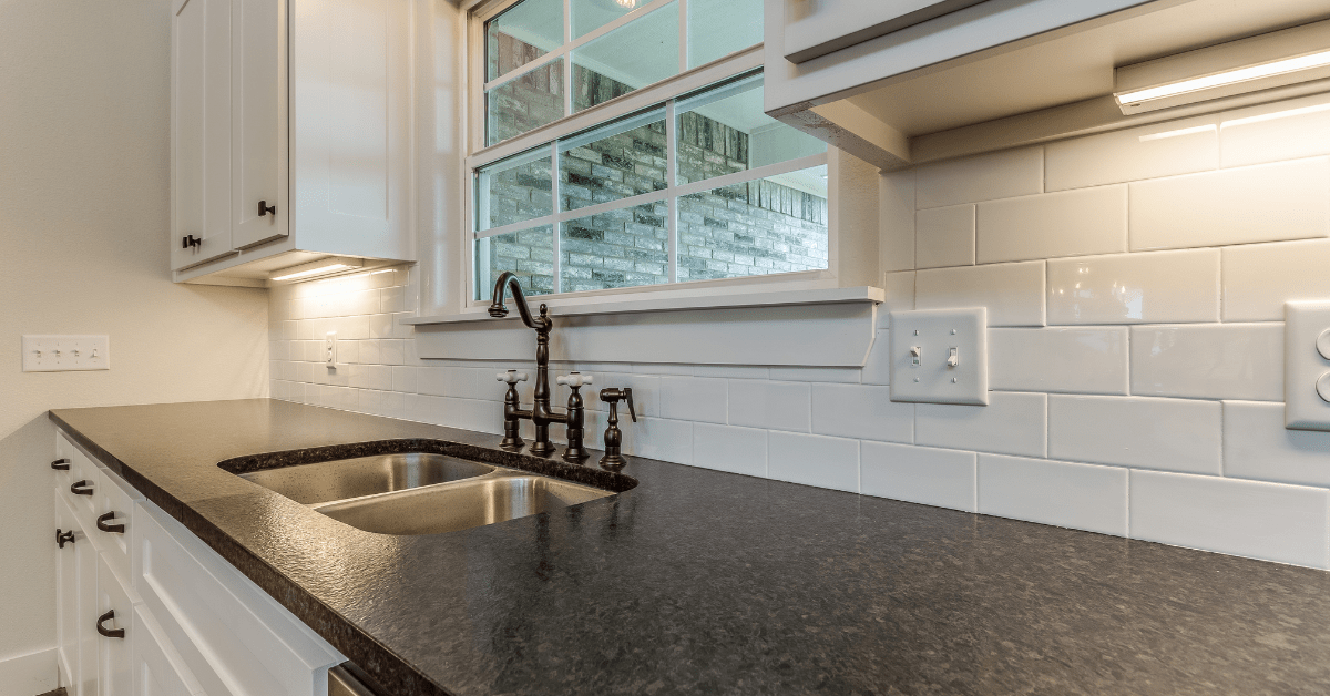 A kitchen with black countertops.