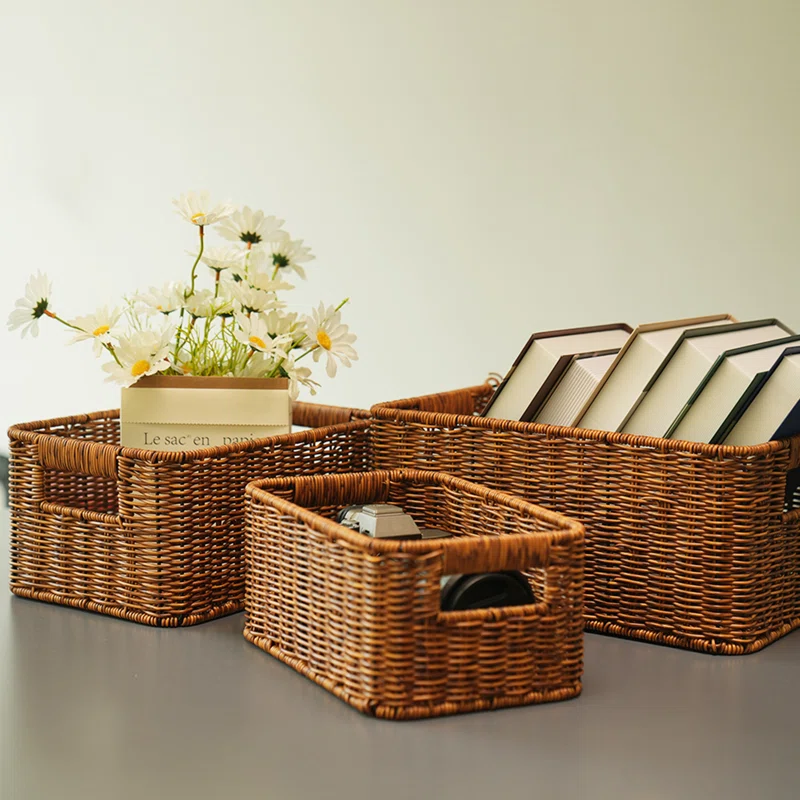 set of three rattan baskets with books and flowers