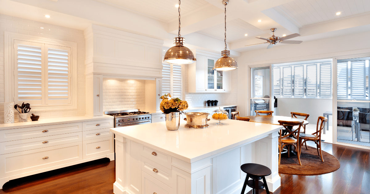 A luxurious kitchen with bronze overhead lights above the kitchen island.