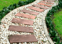 Curved red stone walkway with small stone lining.