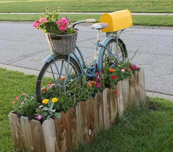 bicycle that has been turned into a yellow mailbox
