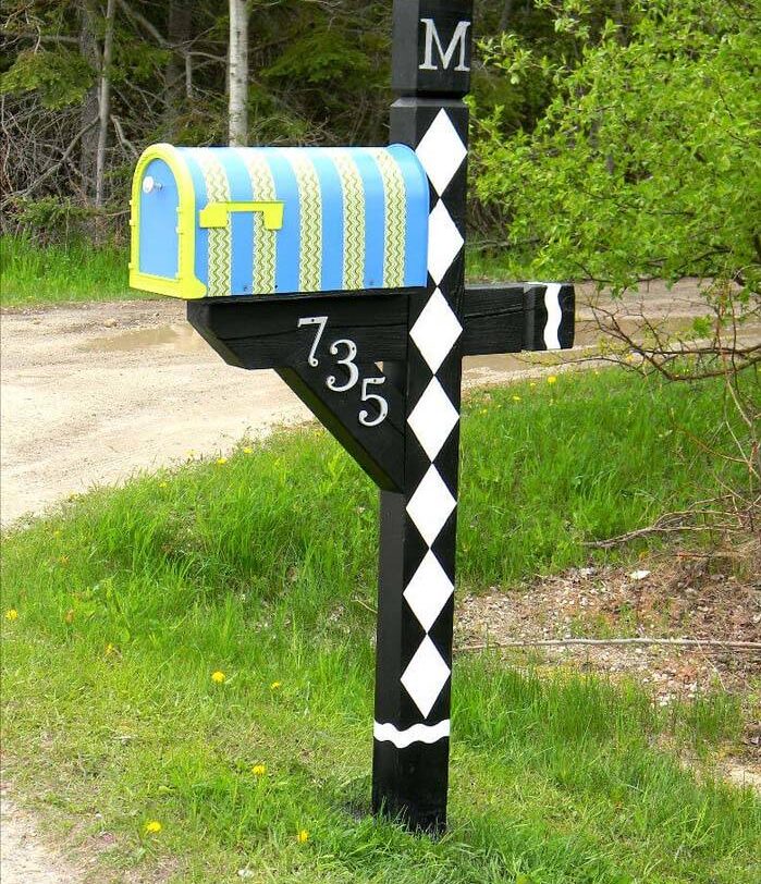 bold and bright mailbox with black post