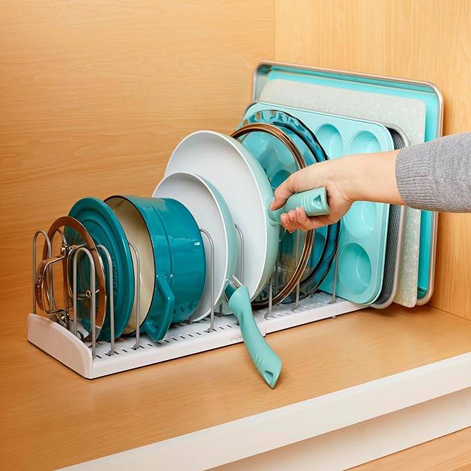 expandable cookware rack with teal pots and pans