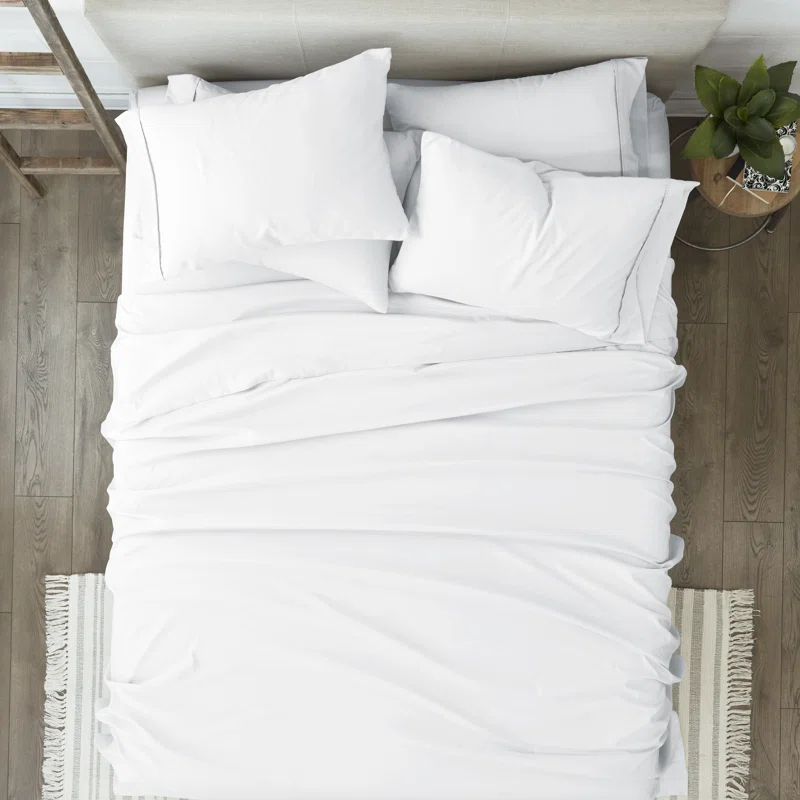 white microfiber bedsheets on bed top view photo