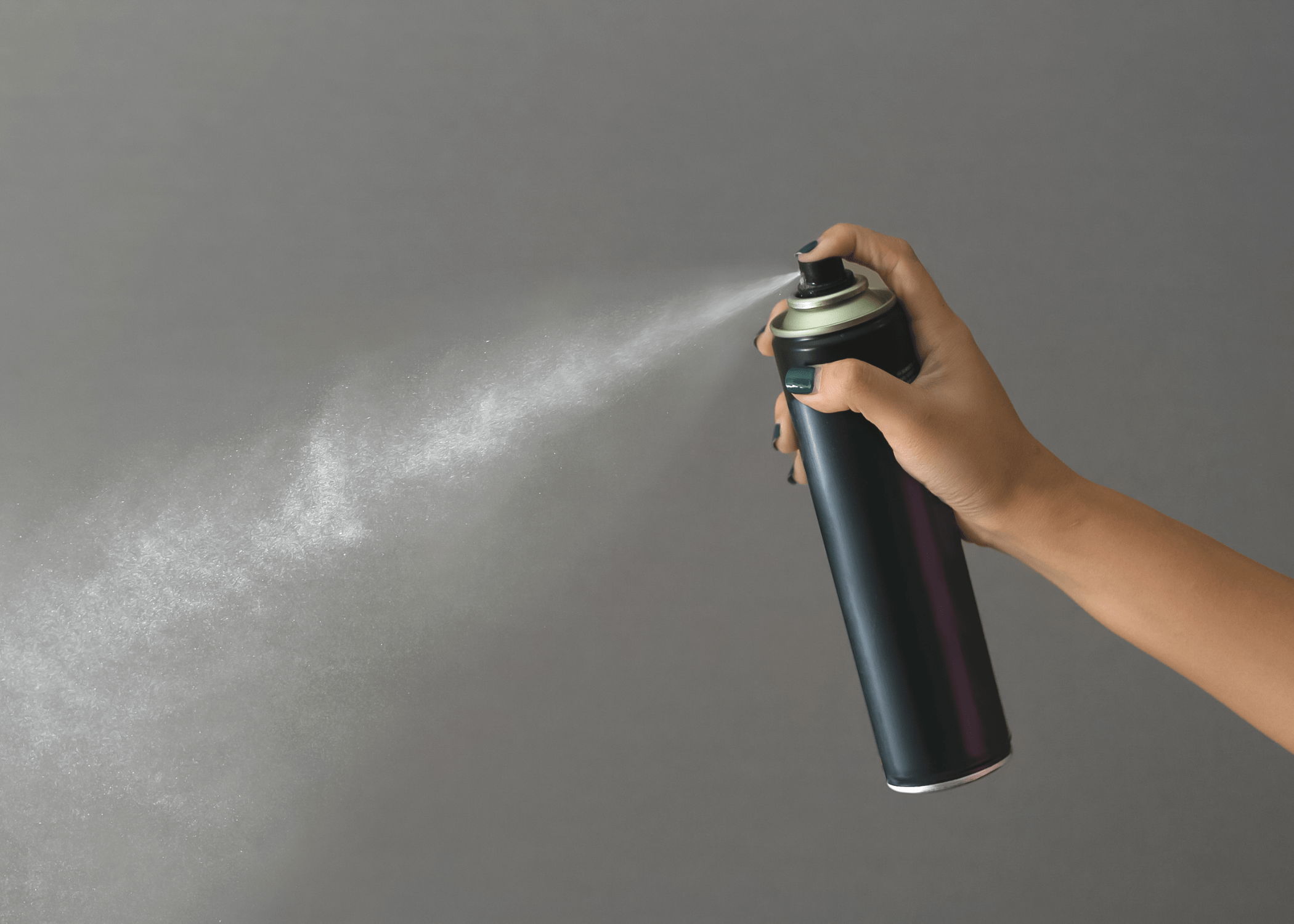 hairspray bottle being sprayed